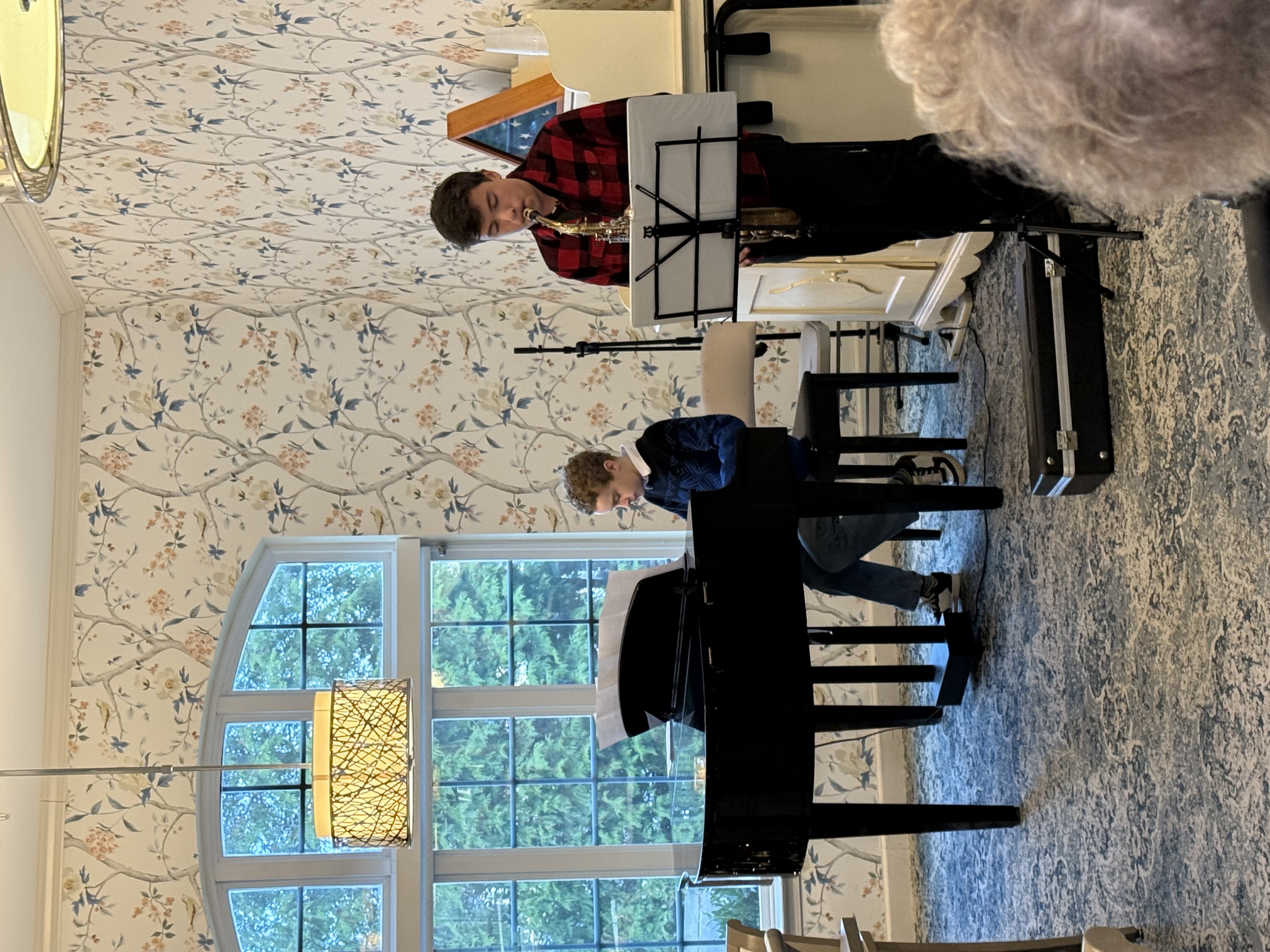 Leland at the piano playing a duet with a saxophonist